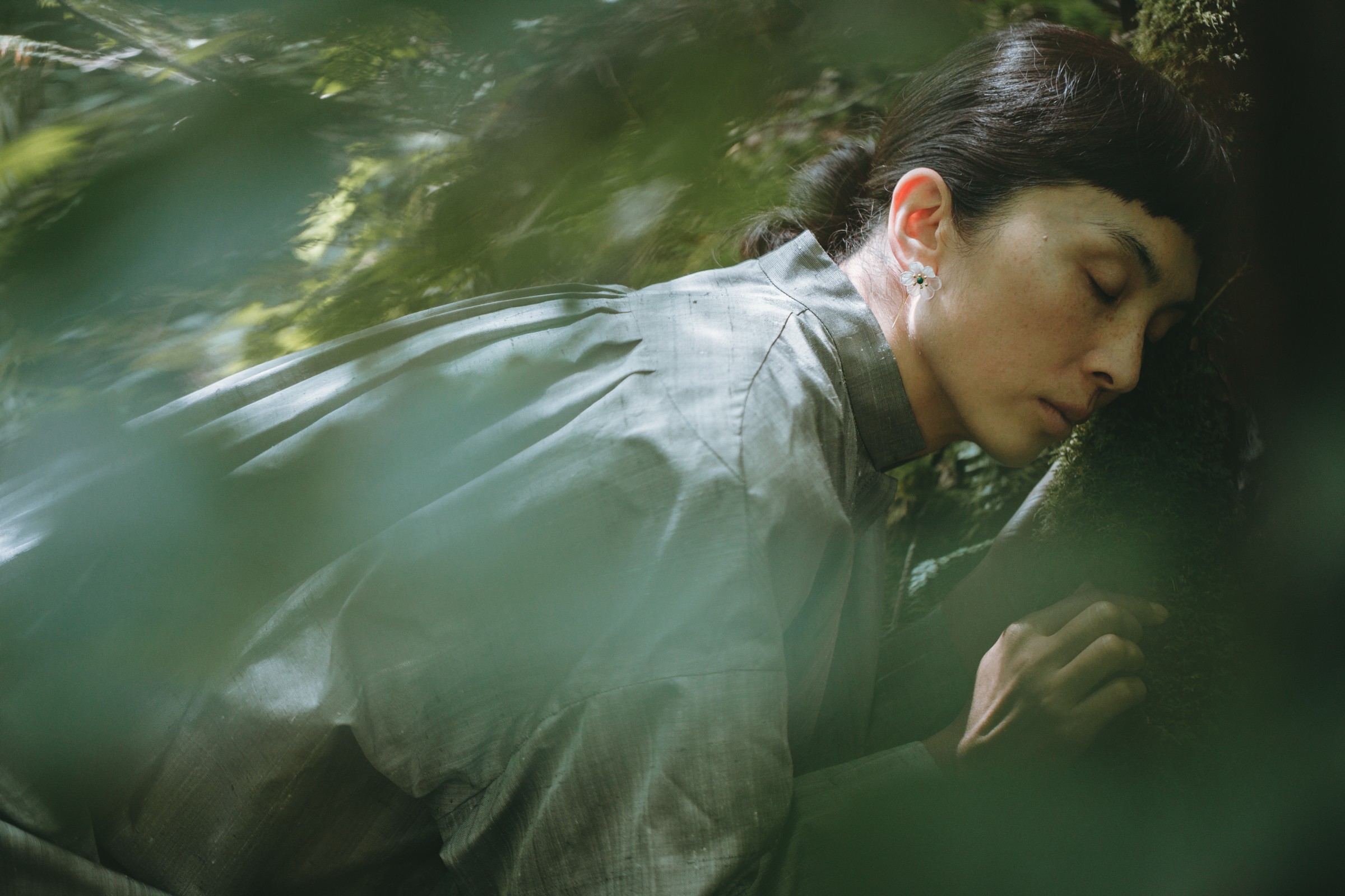 Delicate flowers taped to a wall.