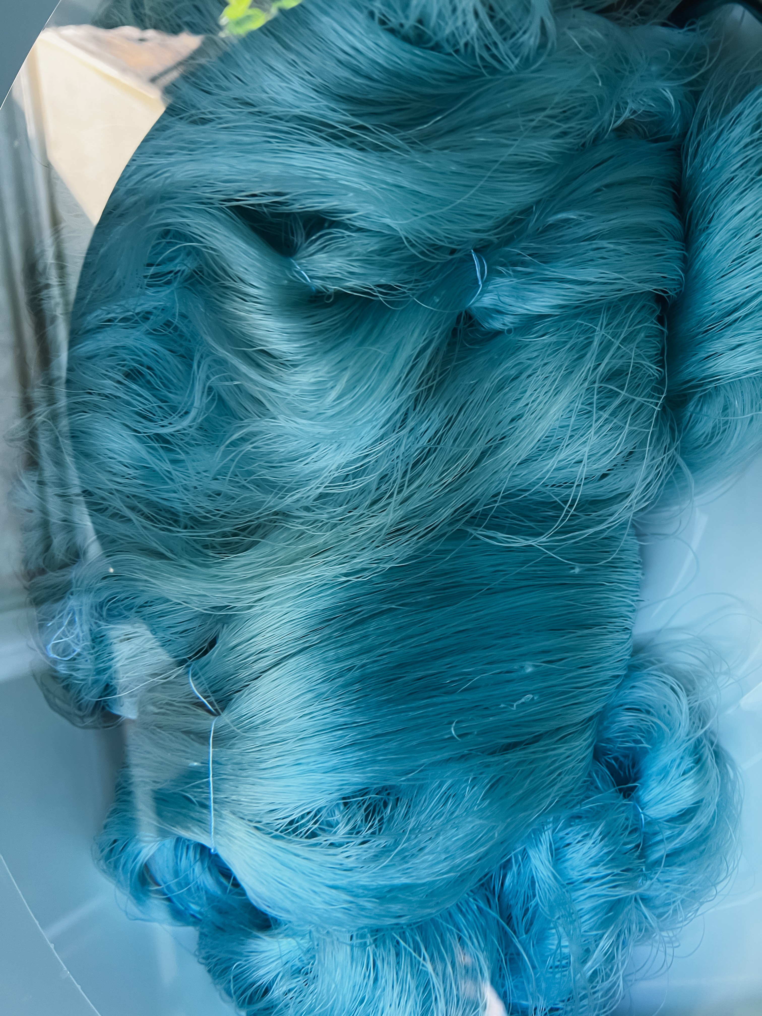 A dried flower rested upon wrinkled pieces of cloth paper.