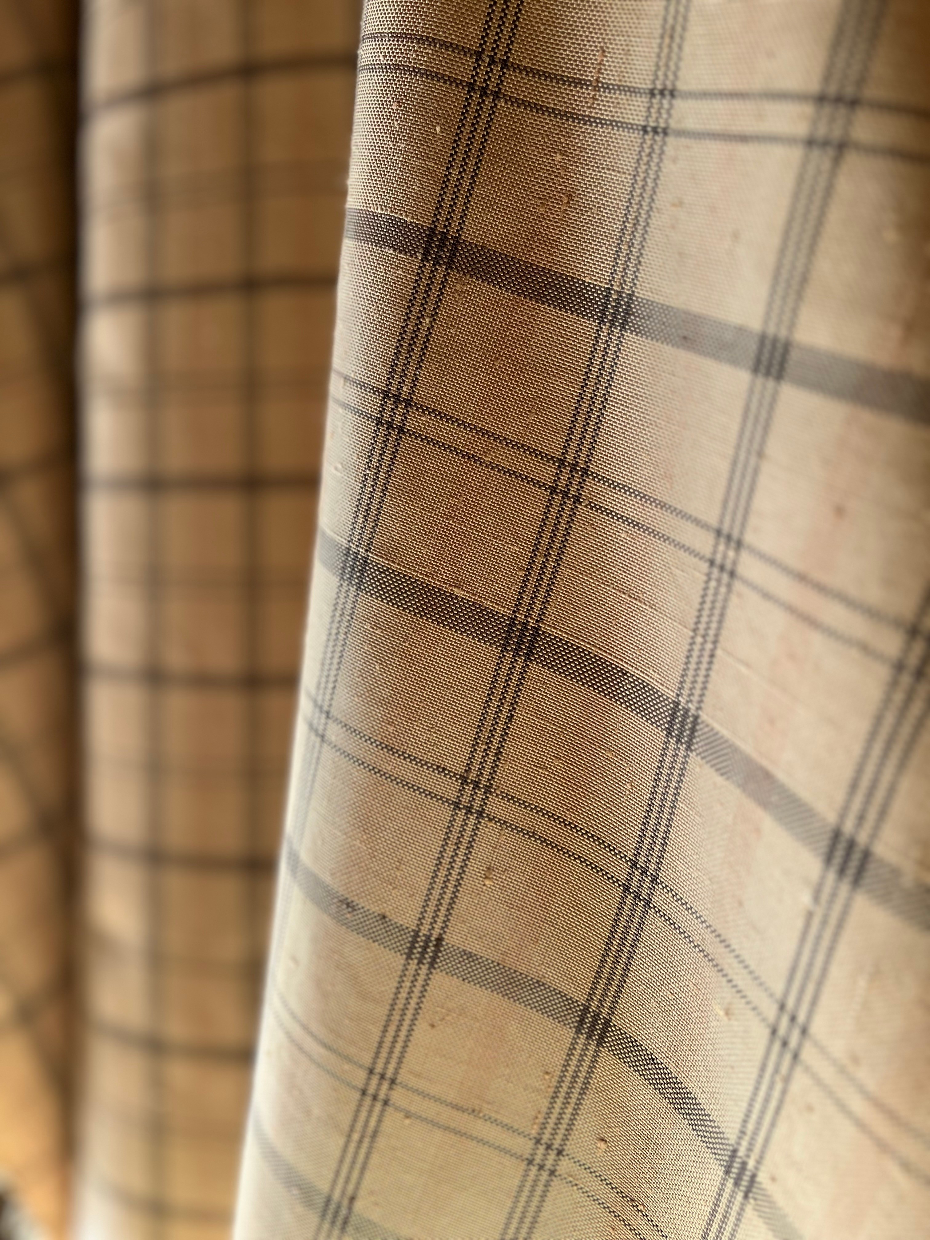 Cropped photo of the exterior of the top floor of an old stone building.